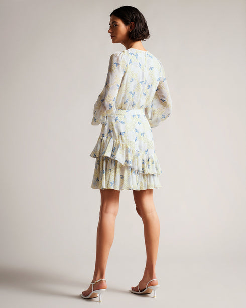 SUZIIEE-Dresses-Make every day a fashion show in SUZIIEE. Featuring our gorgeous poppy print and all the ruffles your heart desires, this versatile mini dress will take you from coffee mornings to dinner dates with ease.The fabric of this product is made with 30% recycled polyester. Using recycled polyester helps divert plastic waste from ending in landfills, and helps us to reduce our dependence on virgin materials. Mini dress Daisy print Long blouson sleeves Asymmetric ruffled hem Self tie neckline Zip fa